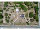 Aerial view of the property showcasing the home, outbuildings, and surrounding landscape at 13341 Hexam Rd, Weeki Wachee, FL 34613
