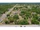 High angle view of property with a home and surrounding green wooded area, next to a road at 13341 Hexam Rd, Weeki Wachee, FL 34613