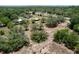 Overhead view of the property including the home, storage units and treed landscape at 13341 Hexam Rd, Weeki Wachee, FL 34613