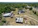 Expansive aerial view displays the property with several buildings, treed acreage, and proximity to nearby roads at 13341 Hexam Rd, Weeki Wachee, FL 34613