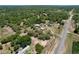 Aerial view of large property featuring a home, various outbuildings, and extensive surrounding greenery at 13341 Hexam Rd, Weeki Wachee, FL 34613