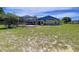 View of the backyard with a screen-enclosed pool, a well maintained lawn and partial view of the home's exterior at 13341 Hexam Rd, Weeki Wachee, FL 34613