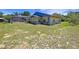 A backyard features a screen enclosed pool and a section of stone accents on the home's exterior at 13341 Hexam Rd, Weeki Wachee, FL 34613