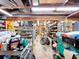 Functional basement/storage area with shelving units, equipment, and ample space for storage or workshop activities at 13341 Hexam Rd, Weeki Wachee, FL 34613