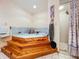 Bathroom featuring a large wooden jacuzzi tub with tiled floors and a separate shower at 13341 Hexam Rd, Weeki Wachee, FL 34613