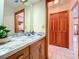 Bathroom with a sink and vanity, hallway, and closet at 13341 Hexam Rd, Weeki Wachee, FL 34613