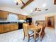 Dining room with wood table, chairs, and updated appliances at 13341 Hexam Rd, Weeki Wachee, FL 34613