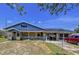 Home's exterior features covered porch, carport, and convenient side entry at 13341 Hexam Rd, Weeki Wachee, FL 34613