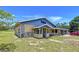 A charming home features unique architecture, stone accents and an inviting covered front porch at 13341 Hexam Rd, Weeki Wachee, FL 34613