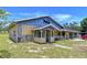 Unique exterior features stone accents, covered porch, and vintage detailing at 13341 Hexam Rd, Weeki Wachee, FL 34613
