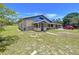 The exterior of this house features a large yard, stone accents, and a charming covered front porch at 13341 Hexam Rd, Weeki Wachee, FL 34613