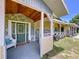 A cozy front porch welcomes you to the home with its unique facade and charming details at 13341 Hexam Rd, Weeki Wachee, FL 34613