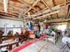 Spacious garage featuring white cabinets and ample storage with exposed rafters and two ceiling fans at 13341 Hexam Rd, Weeki Wachee, FL 34613