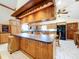 Open kitchen with wood cabinets, center island, and updated appliances at 13341 Hexam Rd, Weeki Wachee, FL 34613