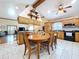Eat-in kitchen with wooden cabinets, granite countertops, a vaulted ceiling, and modern appliances at 13341 Hexam Rd, Weeki Wachee, FL 34613