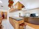 Open concept kitchen with an island, custom cabinetry, tile flooring and views into the living room at 13341 Hexam Rd, Weeki Wachee, FL 34613