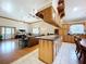 View of the kitchen and living room, the kitchen featuring custom wood cabinets, countertops and tile floors at 13341 Hexam Rd, Weeki Wachee, FL 34613