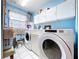 Well-lit laundry room featuring a washer, dryer, and ample storage space at 13341 Hexam Rd, Weeki Wachee, FL 34613