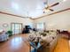 Expansive living room with hardwood floors, multiple ceiling fans, and a cozy sectional sofa at 13341 Hexam Rd, Weeki Wachee, FL 34613