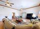 Comfortable living room with wood floors, plentiful seating and an inviting entry way at 13341 Hexam Rd, Weeki Wachee, FL 34613