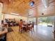 Enclosed patio with wood ceiling, dining area, and tile flooring at 13341 Hexam Rd, Weeki Wachee, FL 34613