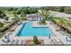 Aerial view of the community pool with lounge chairs and umbrellas at 1396 White Fox Run, Lutz, FL 33549