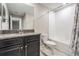Bathroom features vanity with a dark countertop, toilet, and shower at 1396 White Fox Run, Lutz, FL 33549