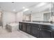 Modern bathroom boasts a dual vanity, granite countertops, and tiled floors at 1396 White Fox Run, Lutz, FL 33549