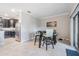 Dining area adjacent to kitchen, featuring modern table and chairs at 1396 White Fox Run, Lutz, FL 33549