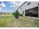Back exterior view of home, with back patio, and backyard with pond at 1396 White Fox Run, Lutz, FL 33549