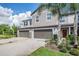Charming two-story townhome featuring attached garages and beautifully landscaped front yard at 1396 White Fox Run, Lutz, FL 33549