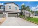 Charming two-story townhome featuring attached garages and beautifully landscaped front yard at 1396 White Fox Run, Lutz, FL 33549