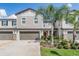 Charming two-story townhome featuring attached garages and beautifully landscaped front yard at 1396 White Fox Run, Lutz, FL 33549