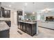 Modern kitchen featuring dark cabinets, granite countertops, stainless steel appliances, and tile flooring at 1396 White Fox Run, Lutz, FL 33549