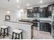 Modern kitchen featuring an open breakfast bar, granite counters, and stainless appliances at 1396 White Fox Run, Lutz, FL 33549
