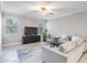 Bright living room showcasing a modern design, neutral tones, and lots of natural light at 1396 White Fox Run, Lutz, FL 33549