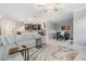Open-concept living room connected to kitchen and dining area, with contemporary furnishings at 1396 White Fox Run, Lutz, FL 33549
