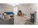 Spacious living room with carpet, couch, futon, shelves and TV at 1396 White Fox Run, Lutz, FL 33549