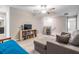 Spacious living room with carpet, couch, loveseat, and book shelves at 1396 White Fox Run, Lutz, FL 33549