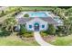 Community pool featuring a building with 'Willow Square' on it, surrounded by palm trees and patio furniture at 1396 White Fox Run, Lutz, FL 33549