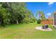 Well-maintained backyard features lush greenery, a seating area, and a tropical setting perfect for relaxation at 14612 Corkwood Dr, Tampa, FL 33626