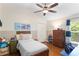 Bedroom showcasing a ceiling fan, wood floors, and closet at 14612 Corkwood Dr, Tampa, FL 33626