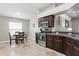 Bright kitchen with dark cabinets, stainless steel appliances, and an adjacent dining area at 14612 Corkwood Dr, Tampa, FL 33626