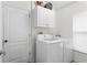 Well-equipped laundry area with modern washer, dryer, and cabinetry for ample storage at 14612 Corkwood Dr, Tampa, FL 33626