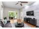 Living room with sliding glass doors to screened patio and a modern decorative plank wall at 14612 Corkwood Dr, Tampa, FL 33626