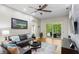 Relaxing living room with sliding glass doors to screened patio, with ceiling fan and hardwood floors at 14612 Corkwood Dr, Tampa, FL 33626
