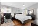 Comfortable main bedroom with ceiling fan, office work area and large window allowing natural light at 14612 Corkwood Dr, Tampa, FL 33626