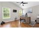 Home office featuring wood floors, dual monitors, and lots of natural light at 14612 Corkwood Dr, Tampa, FL 33626