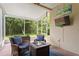 Screened-in patio with cozy seating area and outdoor television at 14612 Corkwood Dr, Tampa, FL 33626