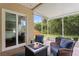 Screened-in patio with cozy seating area overlooking backyard at 14612 Corkwood Dr, Tampa, FL 33626